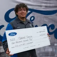 Gabriel Garcia holding a large check