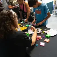 Person behind table showing products and activities