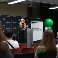 Person standing on a stage behind a podium