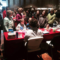 Students surrounding a table learning about programs