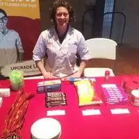 Faculty member at a table sharing about programs