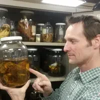 instructor with museum artifact