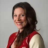 Angie Smith, smiling and wearing a red jacket