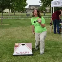 Student wearing CWI Upgrade T-shirt playing cornhole