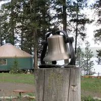 Bell on stump in front of lake