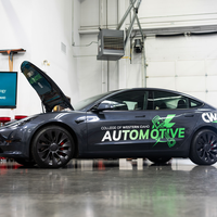 A new Tesla vehicle is displayed on the floor of the Micron Education Center at CWI.