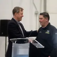 CWI President Gordon Jones shakes hands during an event at CWI.