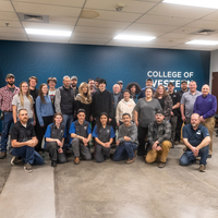 Students and administrators pose with donors for a group photo.