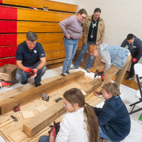 Students learn about trade skills from an instructor.
