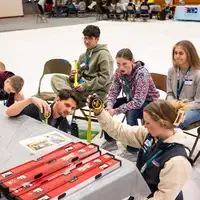 Students learn about trade skills from an instructor.