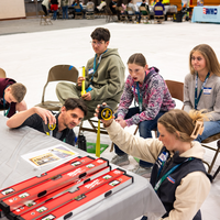 Students learn about trade skills from an instructor.