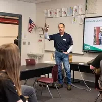 Students learn about trade skills from an instructor.