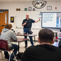 Students learn about trade skills from an instructor.