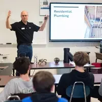 Students learn about trade skills from an instructor.