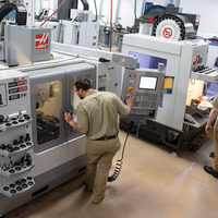 A student works on a metal cutting machine.