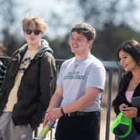 A student and 3 friends laugh.