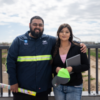 Two people smile as they look into the camera for a portrait.