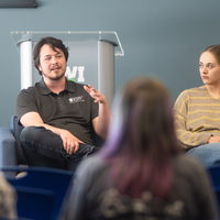 Students, faculty, staff, and more participate in a showcase of student presentations and art.