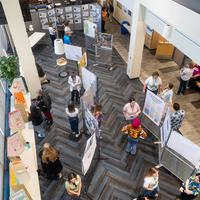 Students, faculty, staff, and more participate in a showcase of student presentations and art.