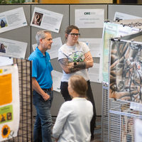 Students, faculty, staff, and more participate in a showcase of student presentations and art.