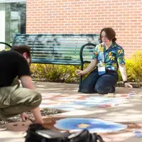 Students, faculty, staff, and more participate in a showcase of student presentations and art.