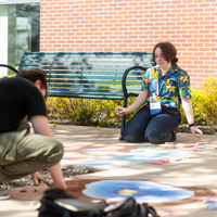 Students, faculty, staff, and more participate in a showcase of student presentations and art.