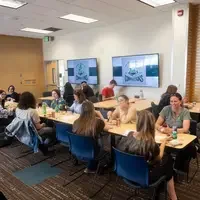 Students, faculty, staff, and more participate in a showcase of student presentations and art.