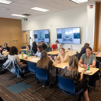 Students, faculty, staff, and more participate in a showcase of student presentations and art.