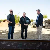 Participants in a beam signing at a construction site. 