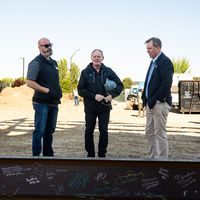 Participants in a beam signing at a construction site. 