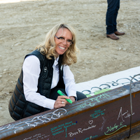 Participants in a beam signing at a construction site. 