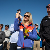 People attending a ceremony at a construction site.