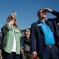 People attending a ceremony at a construction site.