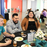 Attendees enjoy and celebrate the achievements of students at a college awards banquet.