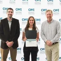 Attendees enjoy and celebrate the achievements of students at a college awards banquet.