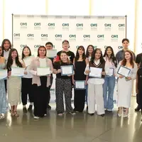 Attendees enjoy and celebrate the achievements of students at a college awards banquet.