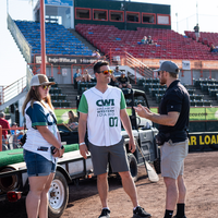 Fans enjoy a night at a baseball game.