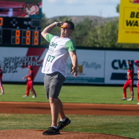 Fans enjoy a night at a baseball game.