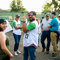 Fans enjoy a night at a baseball game.