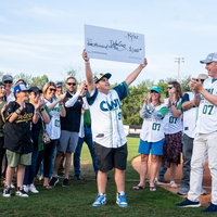Fans enjoy a night at a baseball game.