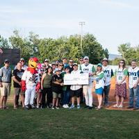 Fans enjoy a night at a baseball game.