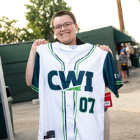 Fans enjoy a night at a baseball game.
