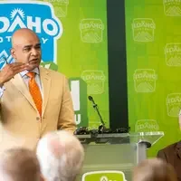 A speaker stands at a podium addressing an audience.