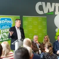 A speaker stands at a podium addressing an audience.