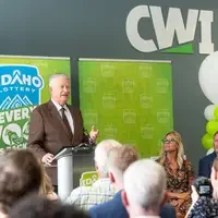 A speaker stands at a podium addressing an audience.