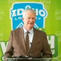 A speaker stands at a podium addressing an audience.