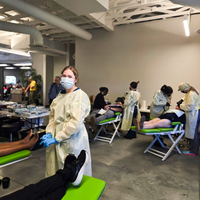 Photographs showing students and others volunteering services in the community.