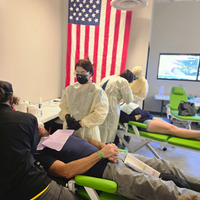 Photographs showing students and others volunteering services in the community.