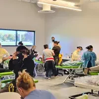 Photographs showing students and others volunteering services in the community.