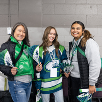 Three women pose for a photo wearing College of Western Idaho apparel. 